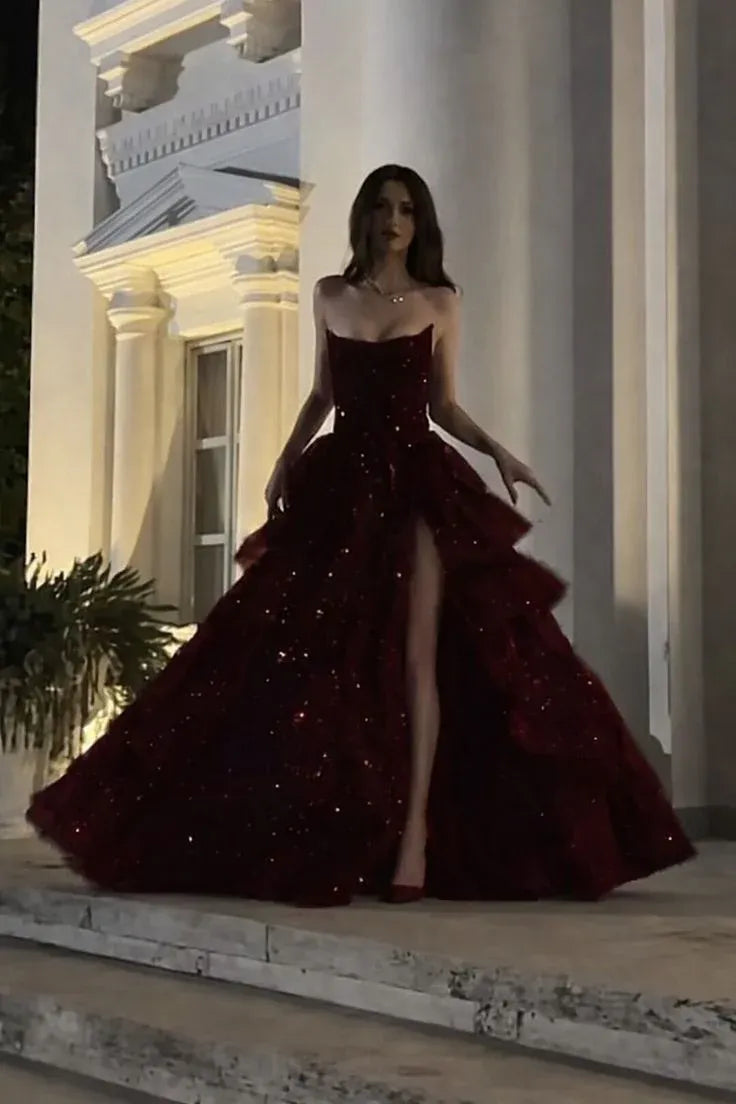Model posing gracefully in the black sequin A-line prom dress at a formal event.