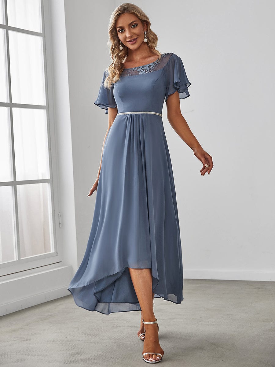 Model wearing a dark blue Weitese A-line midi dress with boat neck and asymmetrical hem.