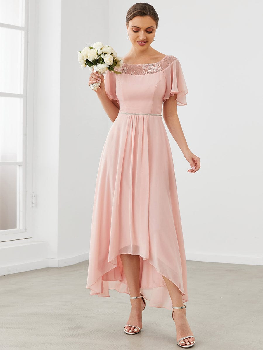 Model wearing a pink Weitese A-line midi dress with boat neck and asymmetrical hem.