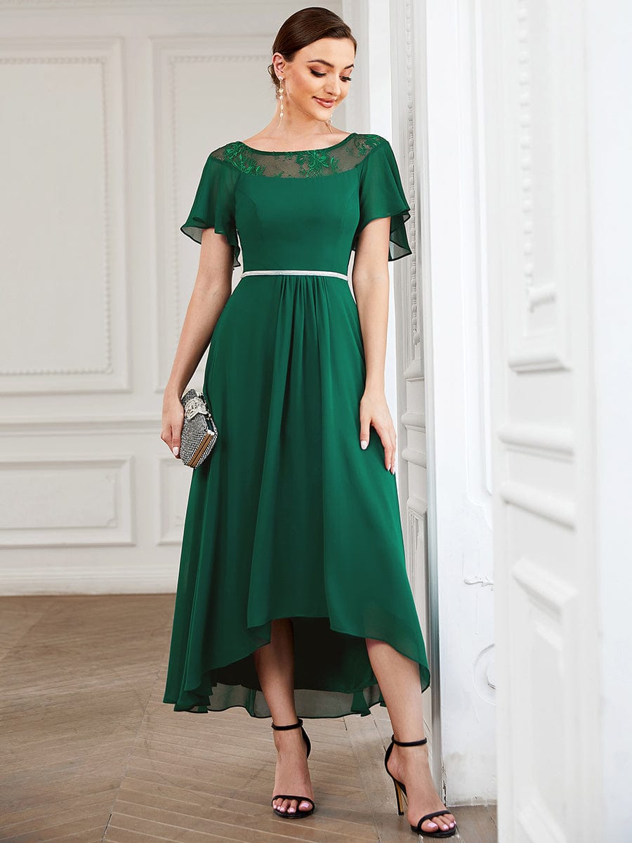 Model wearing a dark green Weitese A-line midi dress with boat neck and asymmetrical hem.