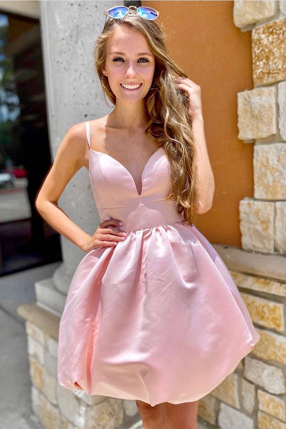 Model wearing a Weitese pink A-line spaghetti strap homecoming dress with a decorative bowtie.