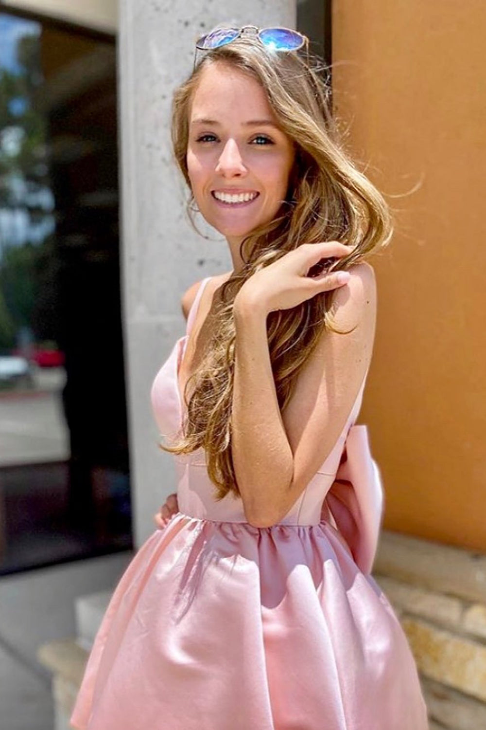 Back view of the Weitese pink A-line spaghetti strap dress, highlighting the bowtie detail.