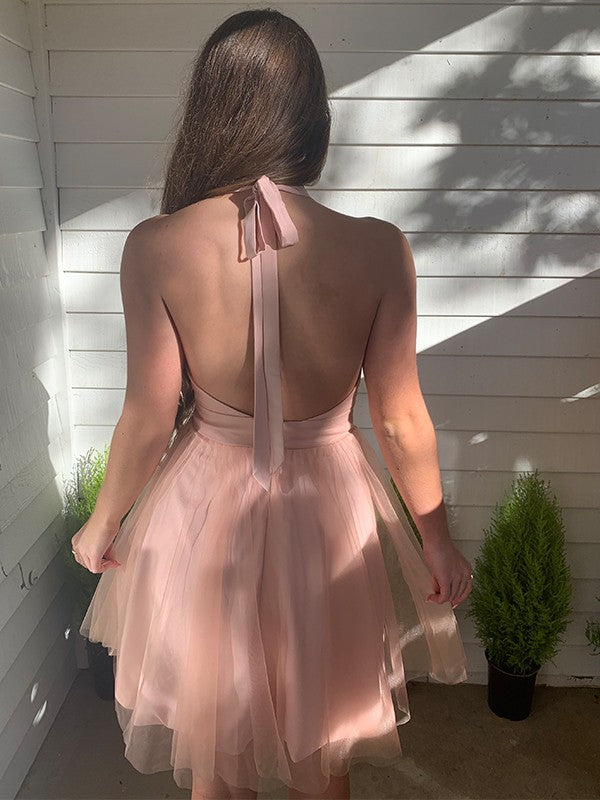 Back view of the blush pink A-line ruffled homecoming dress.