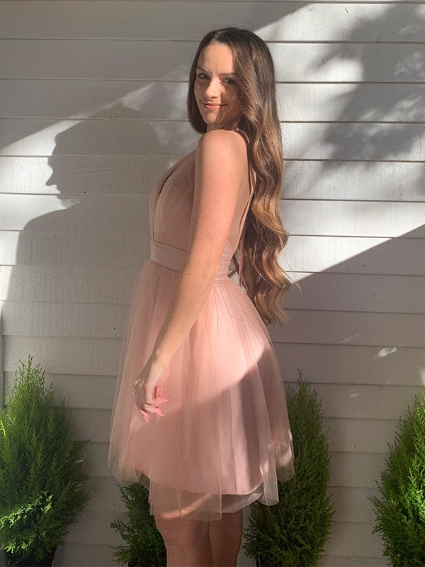 Side profile of a model in the blush pink A-line mini dress.