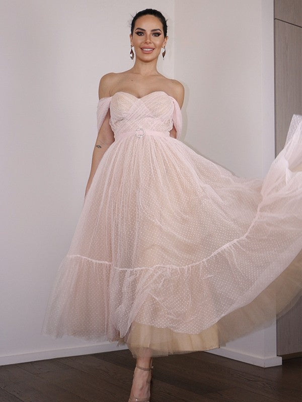 Model wearing a light-colored Weitese A-Line off-shoulder lace tea-length homecoming dress.
