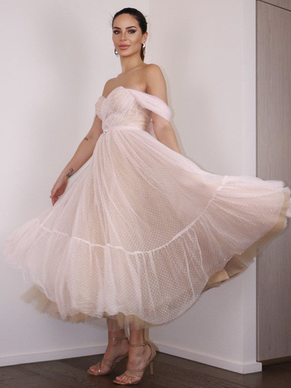 Back view of a model wearing the Weitese A-Line off-shoulder tea-length homecoming dress.