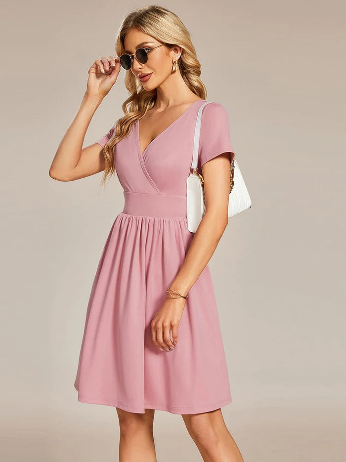 Side profile of a model in the Weitese V-neck mini dress, demonstrating its length.