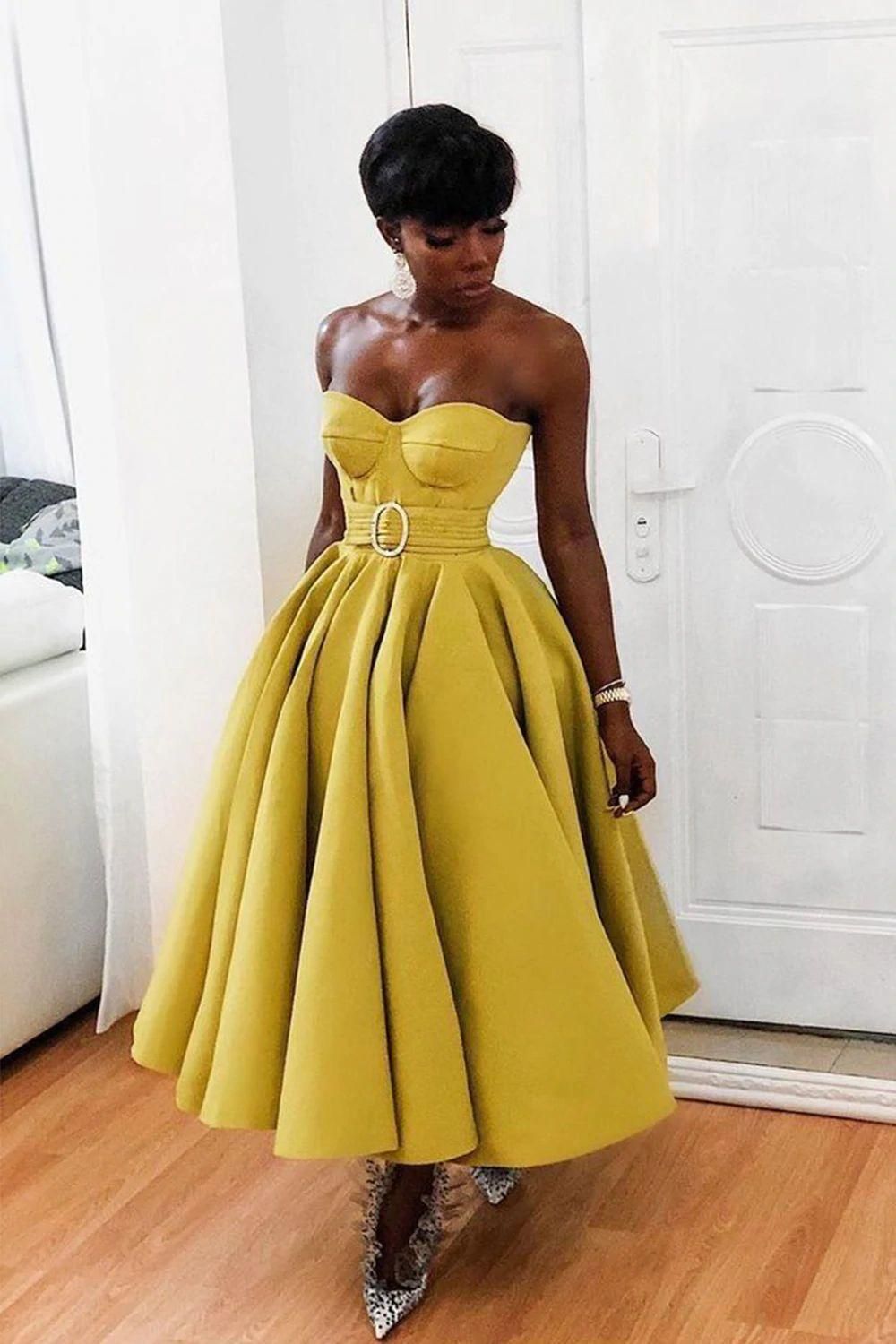 Full view of the yellow A-line strapless dress, highlighting the belt detail.