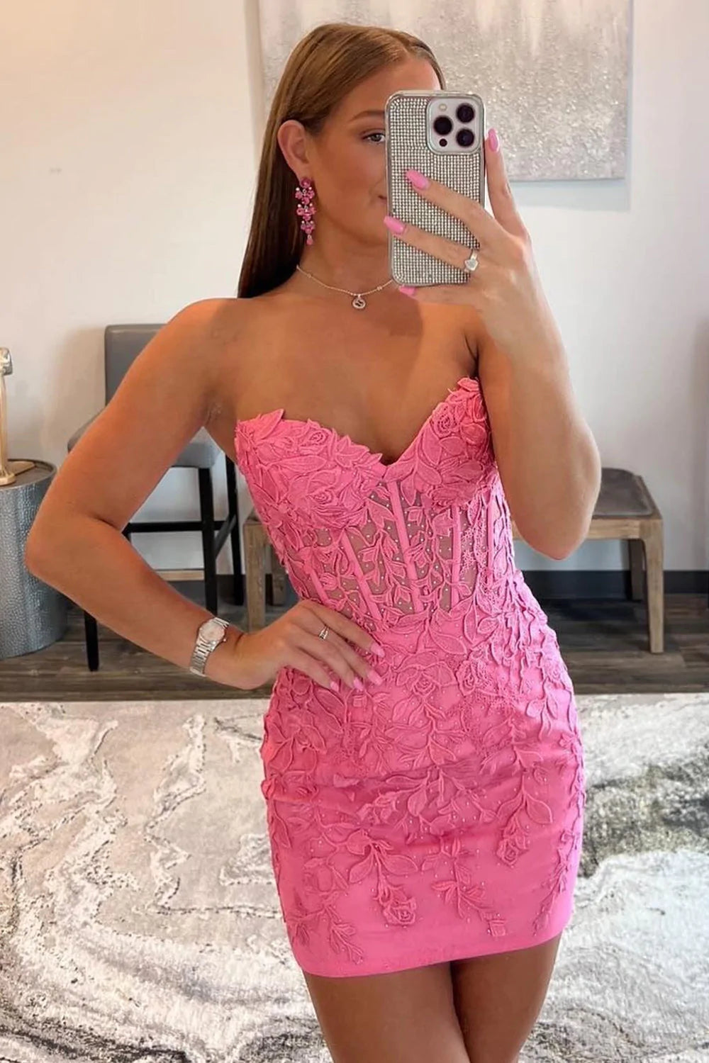 Model wearing a hot pink bodycon homecoming dress with sweetheart neckline and appliques.
