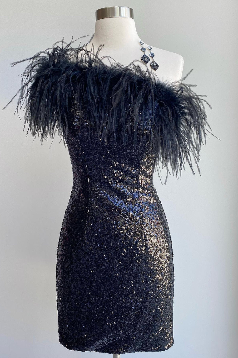 Black bodycon sequin mini dress with feather trim, front view.