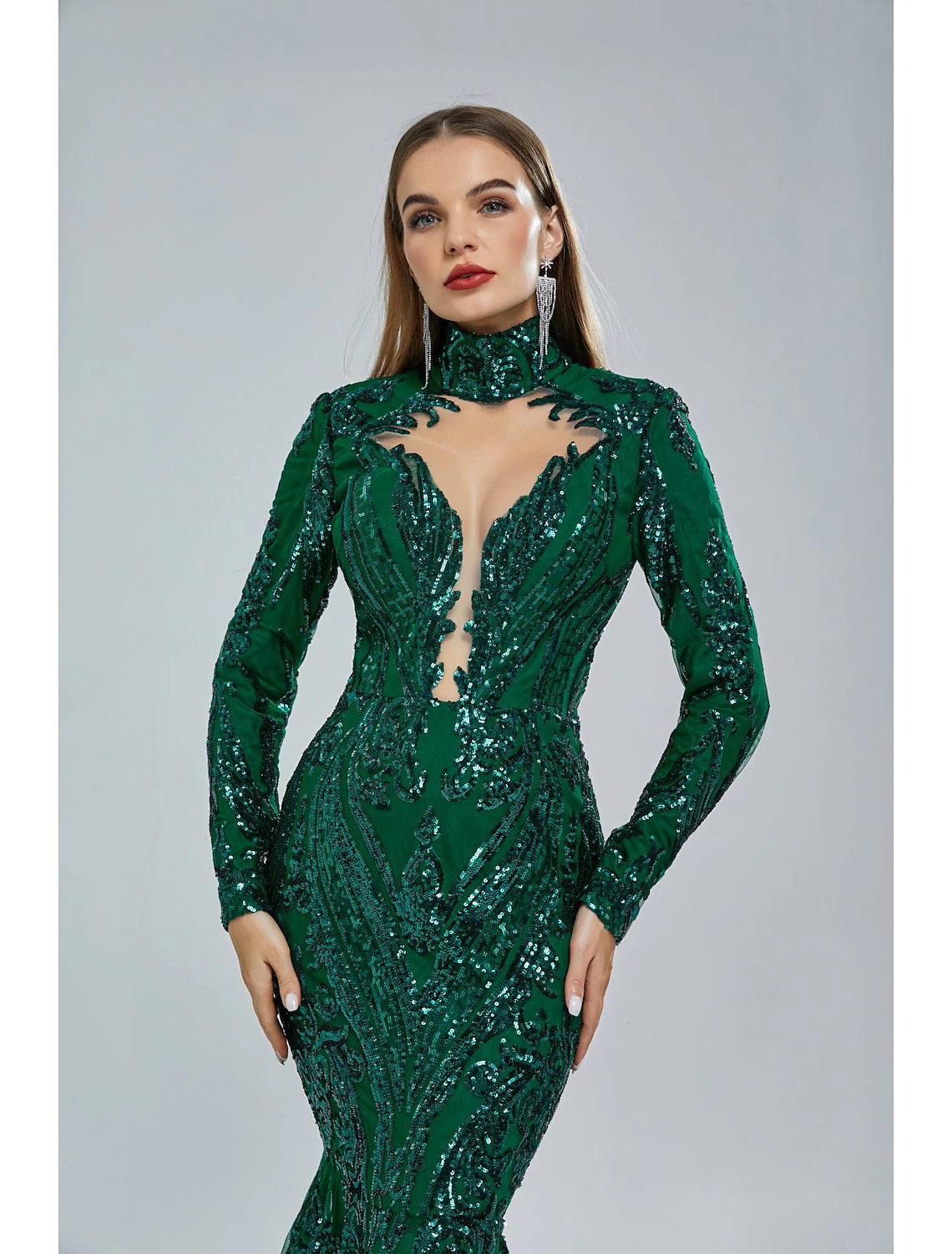 Woman in a red sequin mermaid gown, highlighting the long sleeves and stand collar.