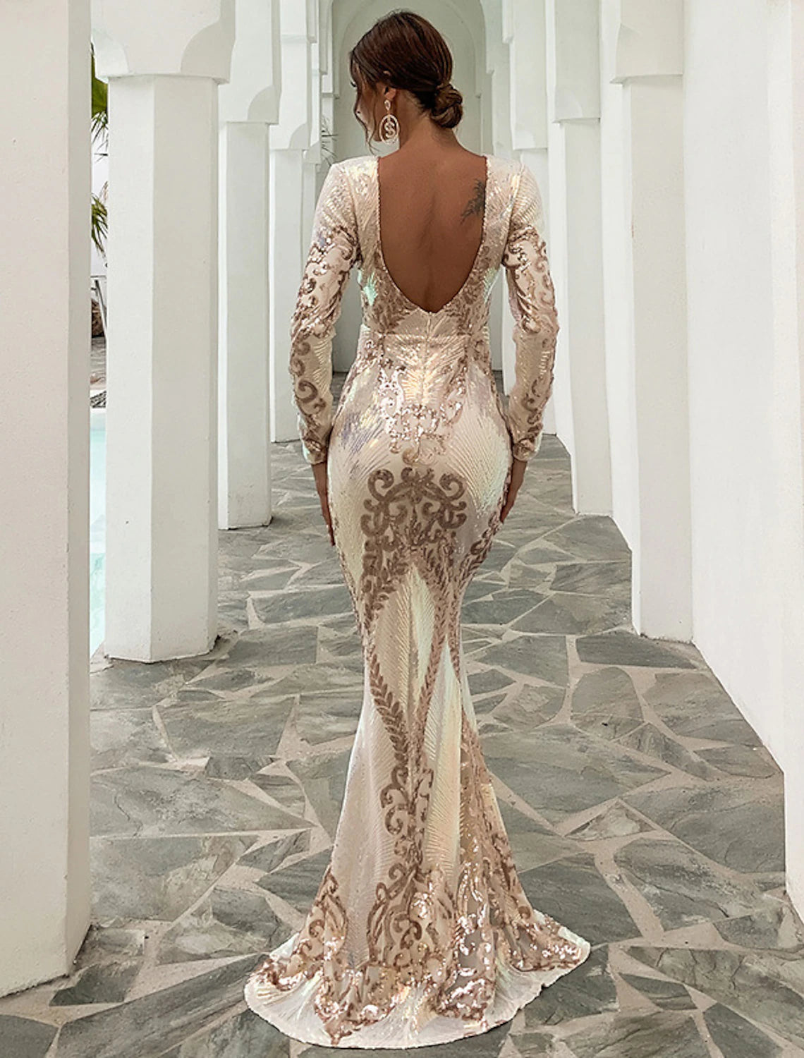Back view of the sequin mermaid trumpet gown, showcasing its elegant backless design and sweep train.
