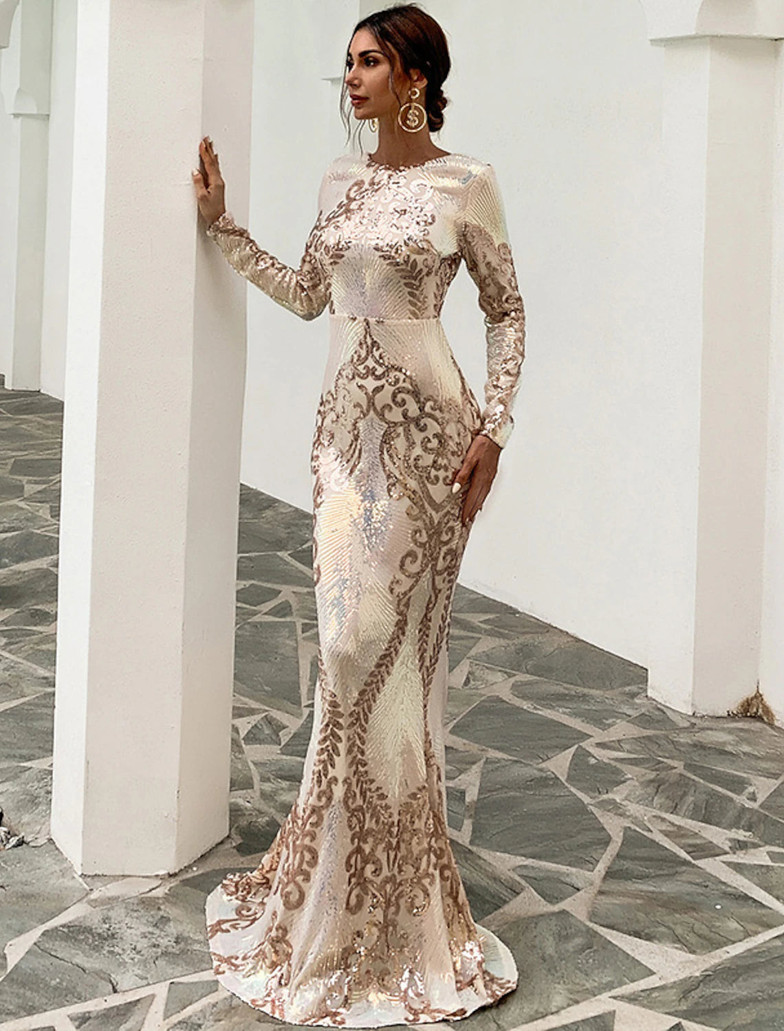Close-up of the shimmering sequin fabric and long sleeves of the formal evening gown.