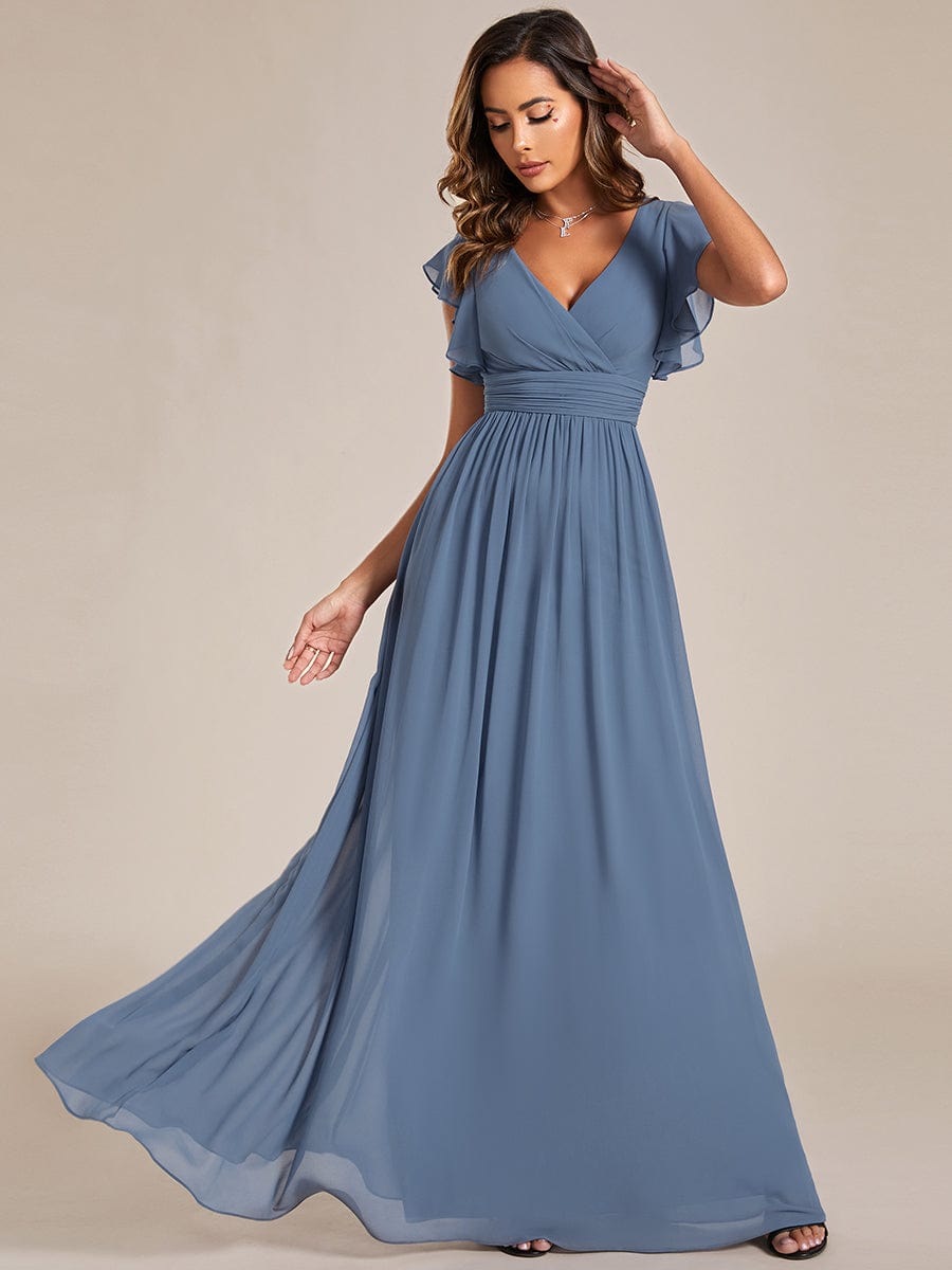 Front view of a dusty navy A-line chiffon bridesmaid dress with pleated bodice.