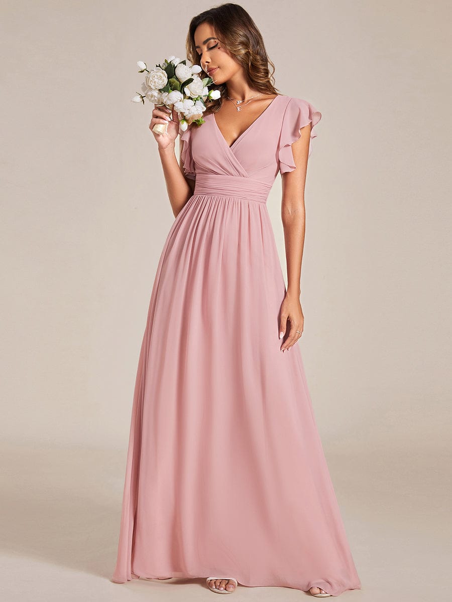 Model in a dark red A-line chiffon bridesmaid dress, displaying the back design.