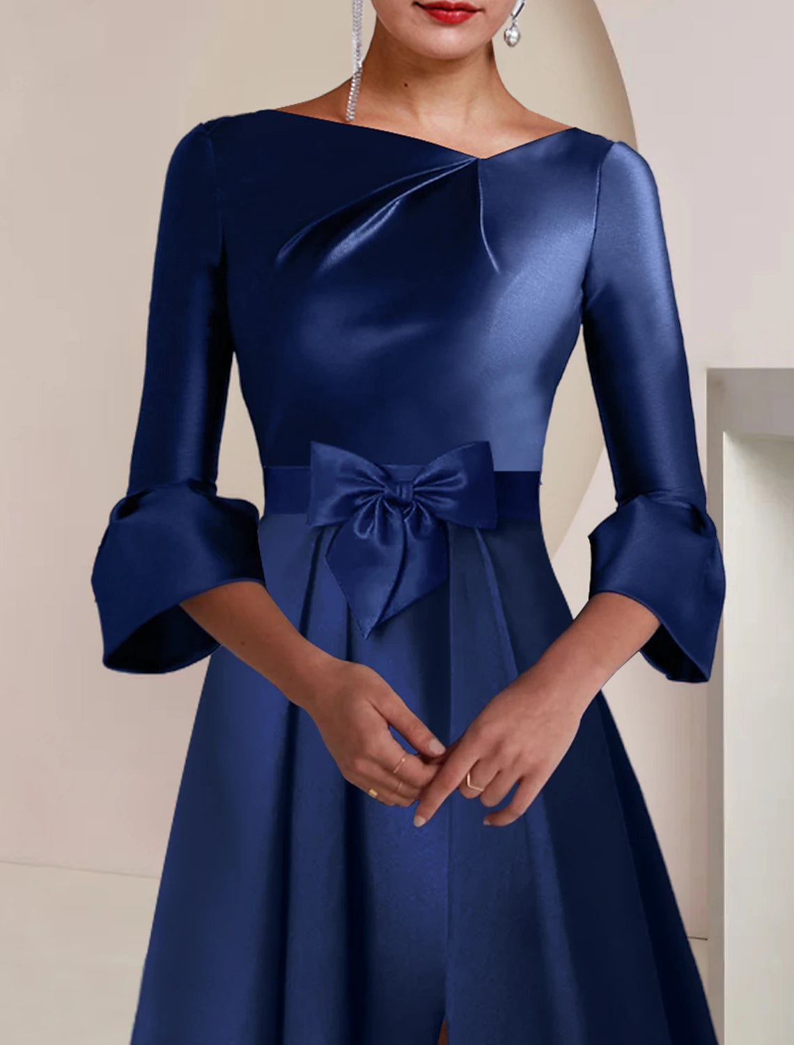 Back view of the elegant satin dress, featuring delicate bows.