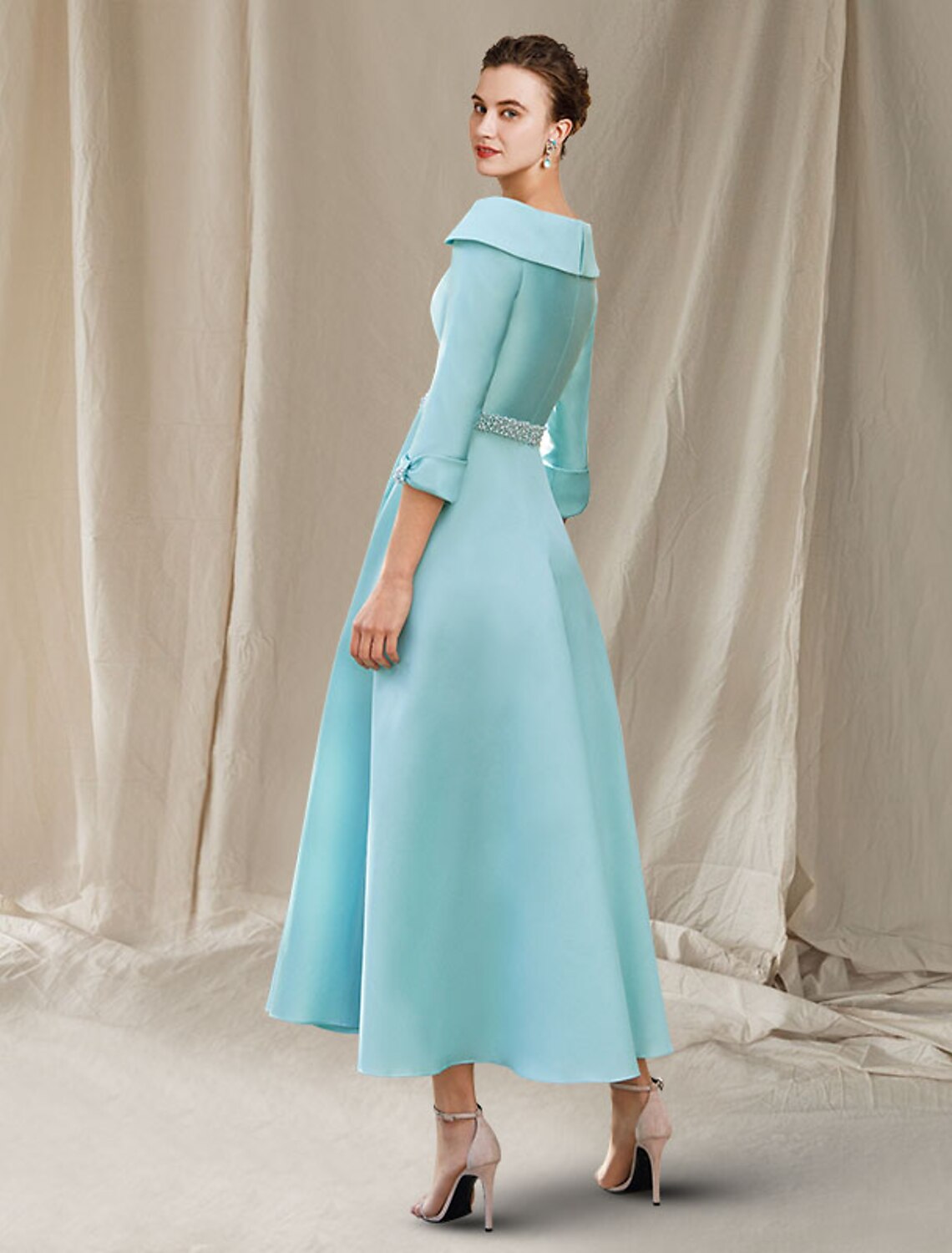 Close-up of the satin A-Line dress showing bateau neck, 3/4 sleeves, and delicate beading.