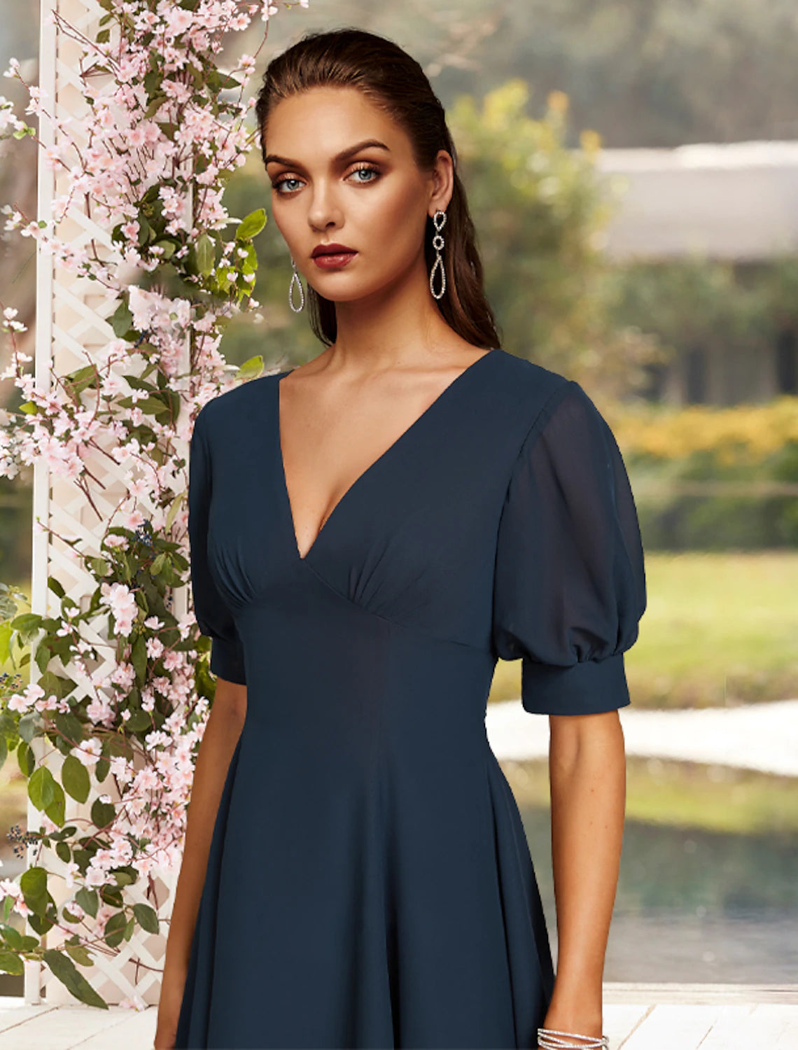 Woman posing in the flowing A-line tea length chiffon dress.