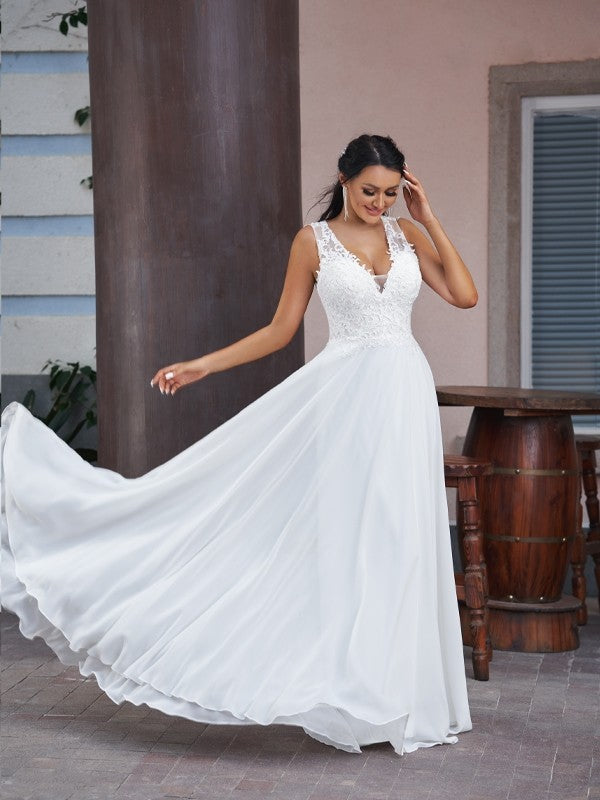 Front view of a bride in an elegant A-line V-neck chiffon and lace wedding dress.