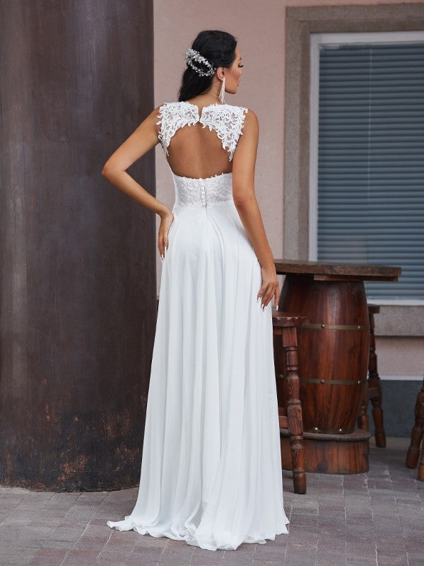 Side profile of a bride wearing a floor-length A-line V-neck lace wedding gown.