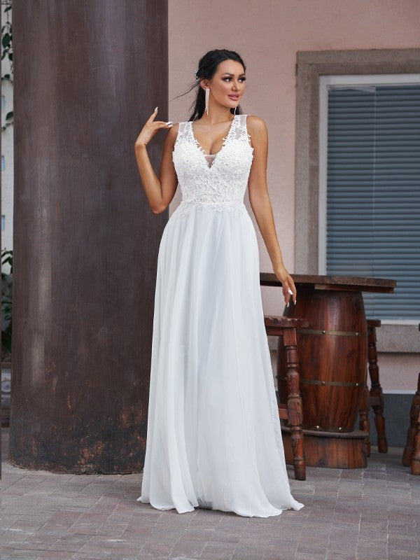 Close-up of the delicate lace bodice and V-neckline on the wedding dress.