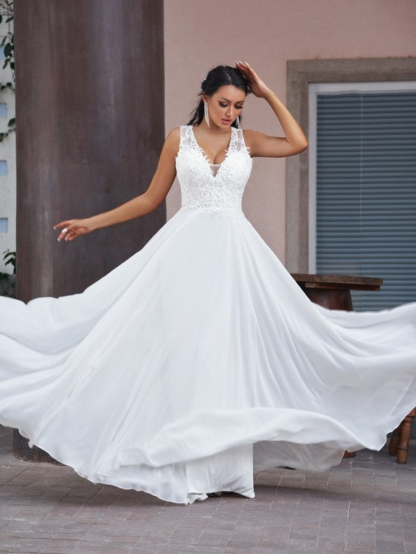 Back view of a bride in the flowing A-line chiffon and lace wedding dress.