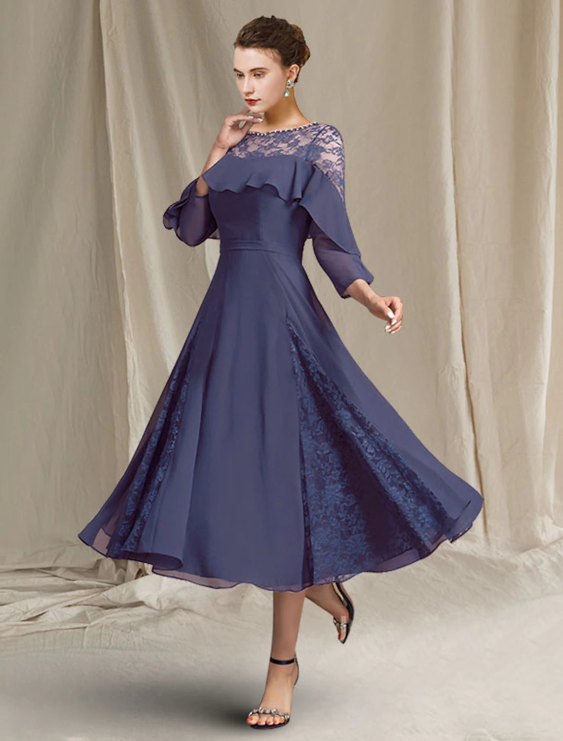 Woman wearing Weitese A-Line chiffon mother of the bride dress with jewel neck and 3/4 sleeves, front view.