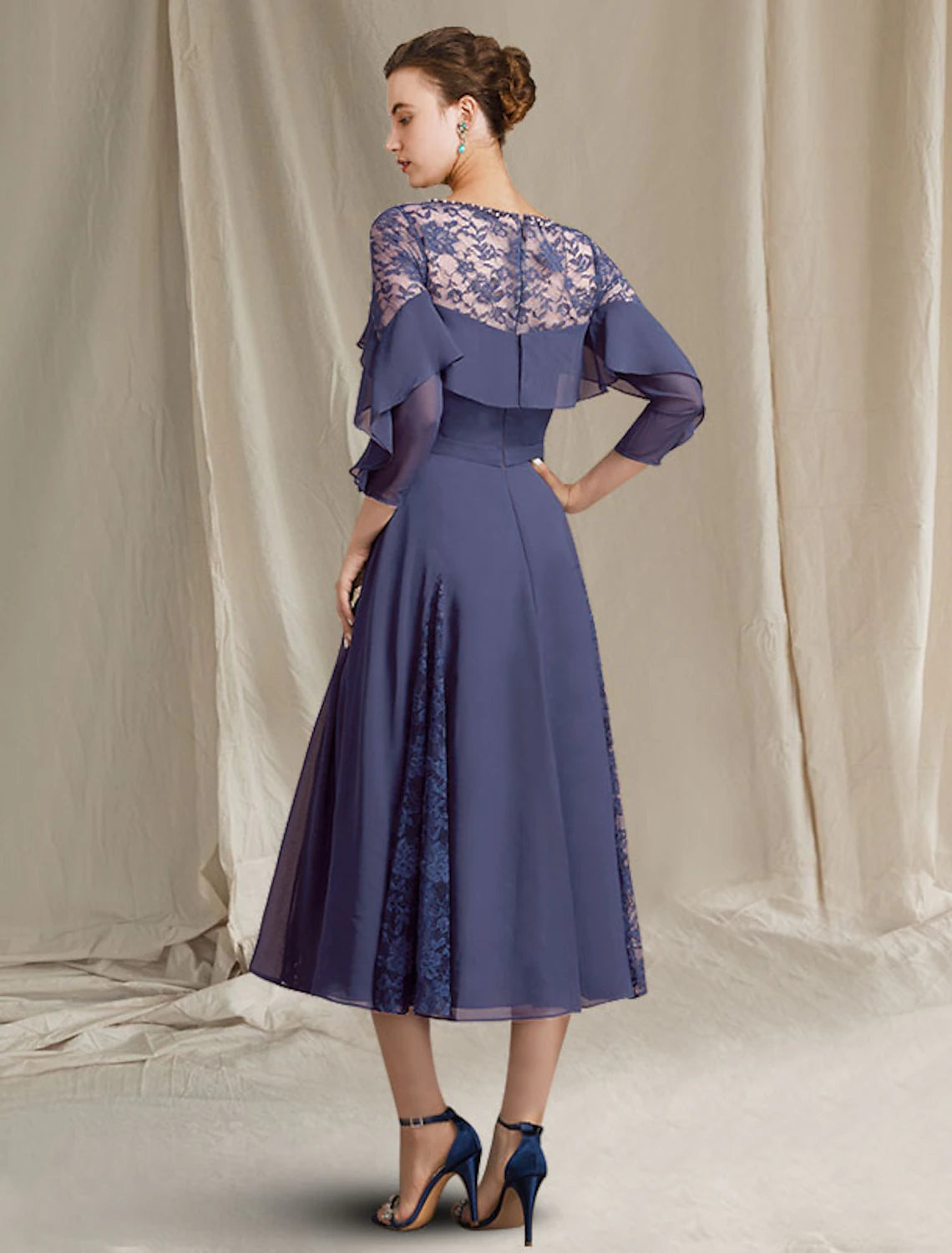 Back view of Weitese A-Line chiffon dress, showing tea length, pleats, and sequin ruffles.