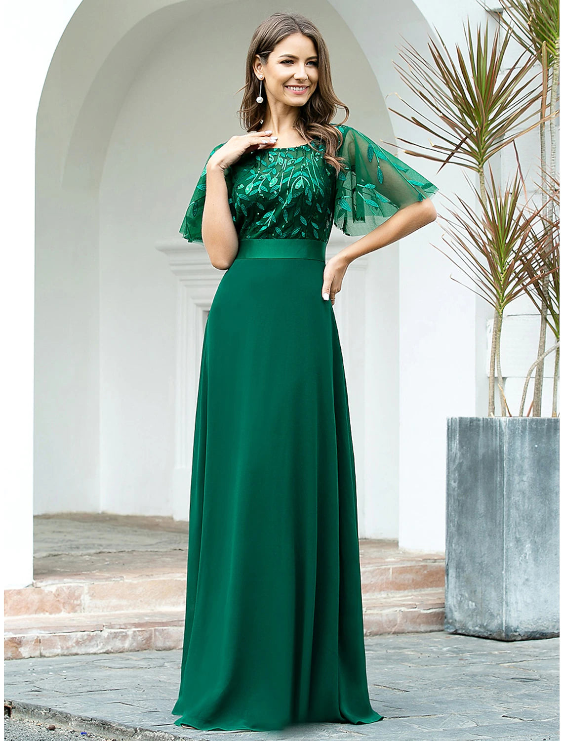 Side profile of a floor-length A-Line chiffon dress.