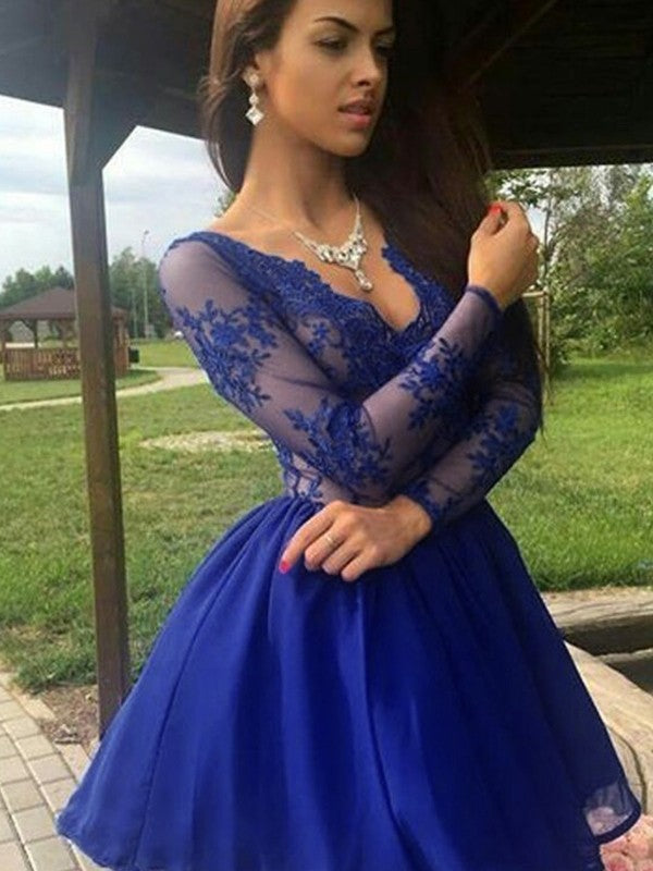 Woman wearing an elegant A-line chiffon V-neck short dress with long sleeves and delicate applique details.