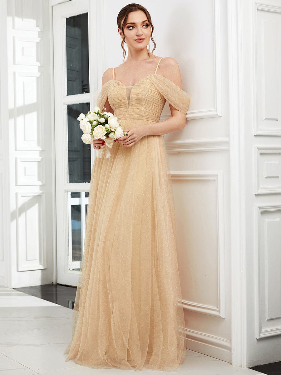 Model wearing a gold Weitese cold shoulder sequin tulle bridesmaid dress, front view.