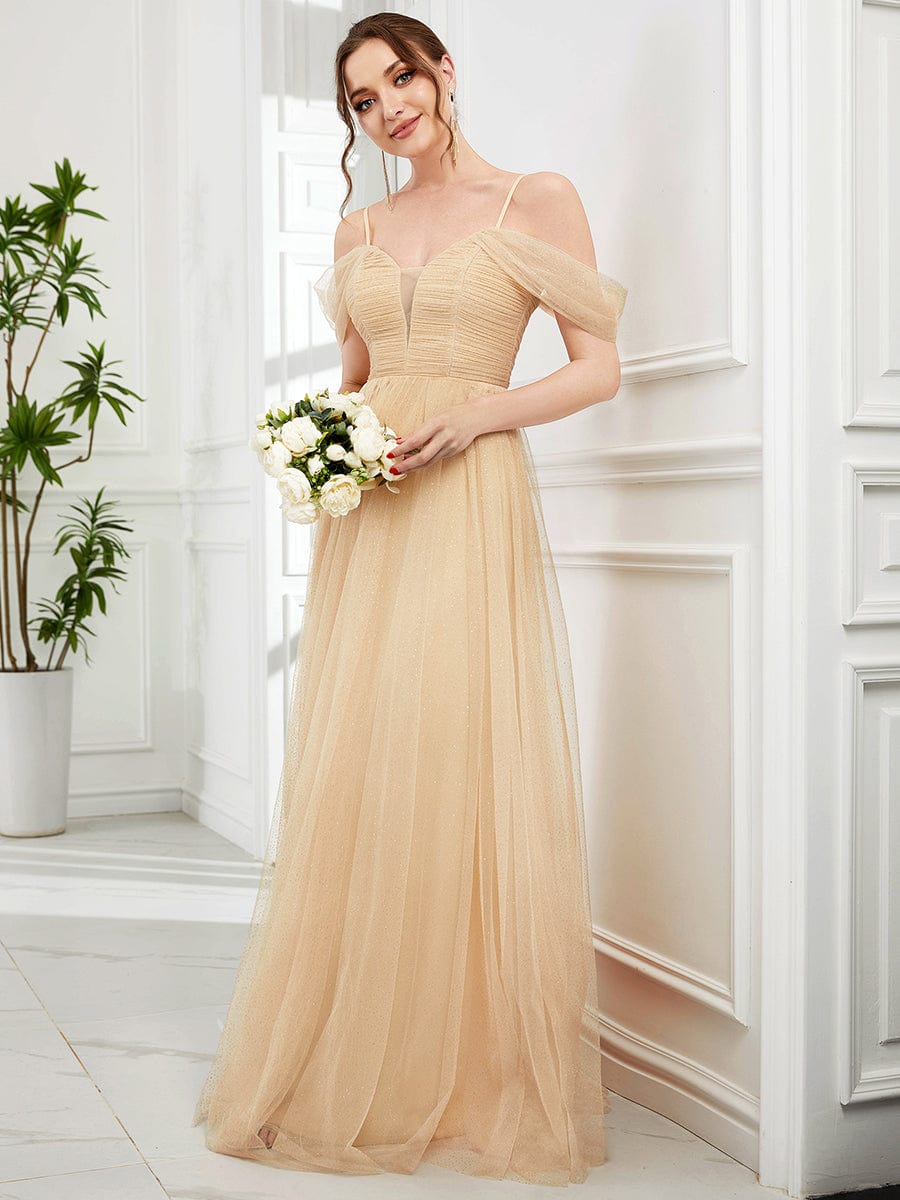 Back view of a model wearing the gold Weitese pleated sequin tulle dress.