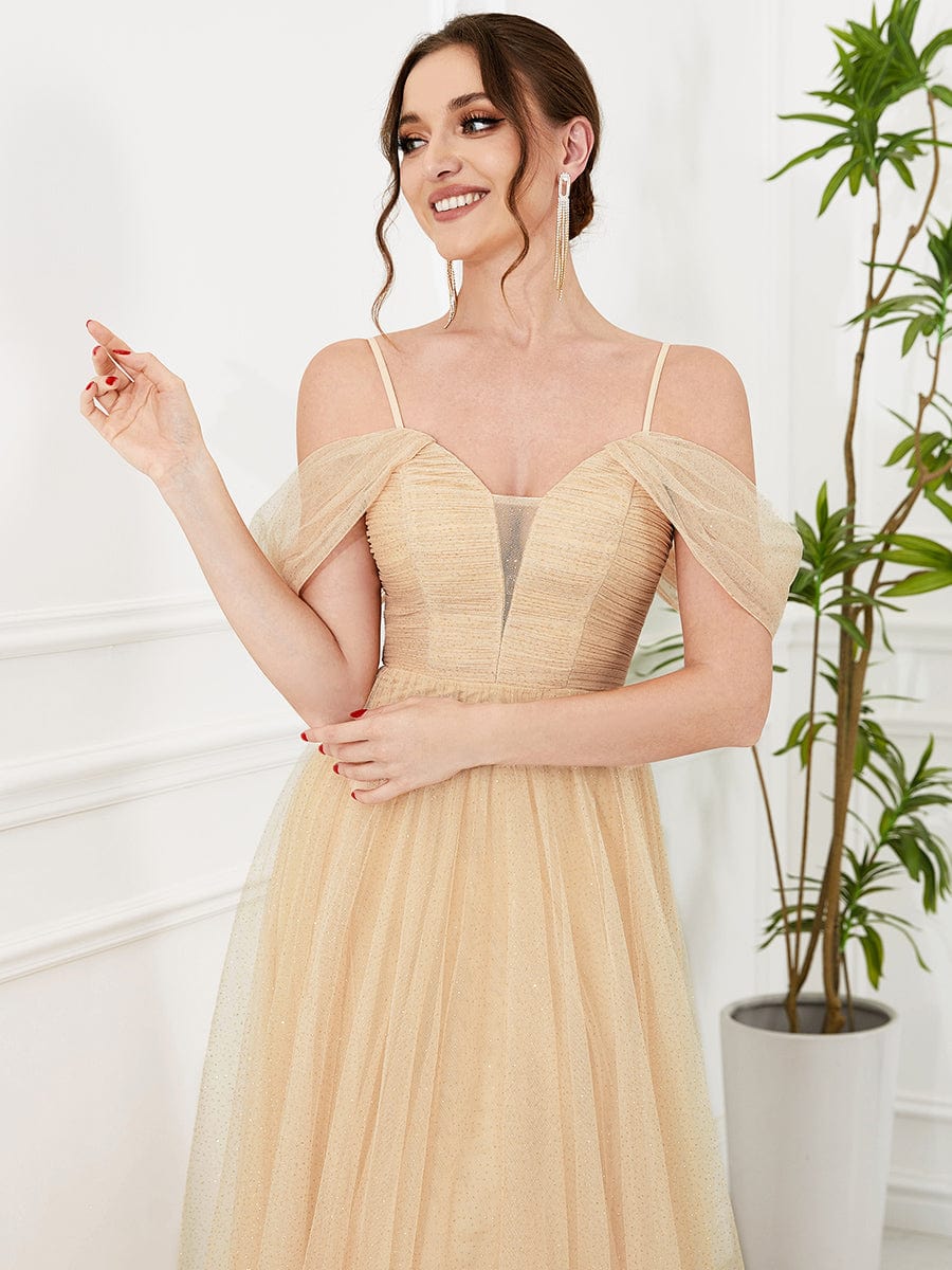 Close-up of the sequin bodice and cold shoulder detail on the gold bridesmaid dress.