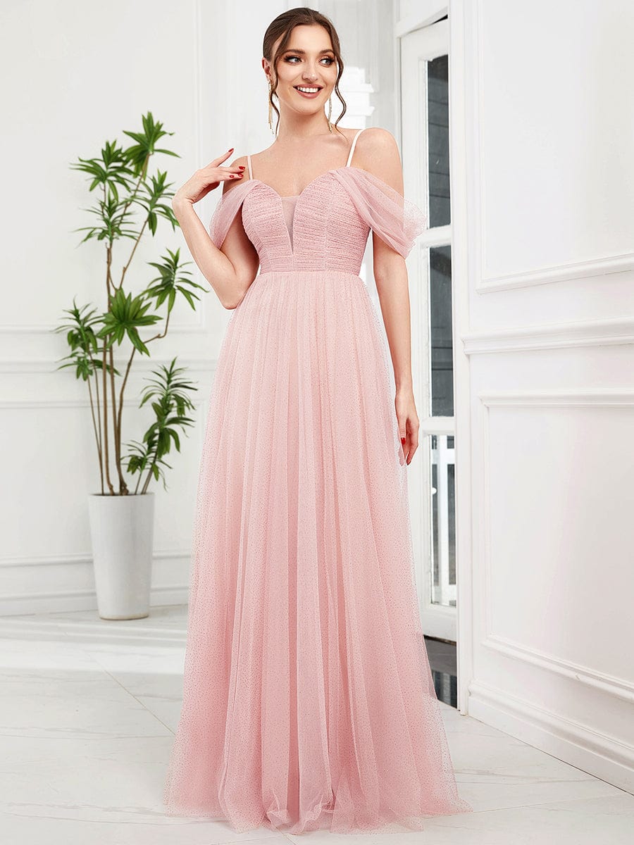 Model wearing a pink Weitese cold shoulder sequin tulle bridesmaid dress, front view.
