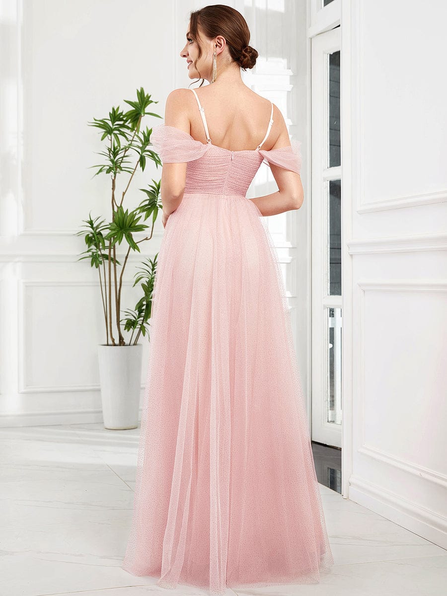 Model in a pink Weitese cold shoulder sequin tulle bridesmaid dress, side view.