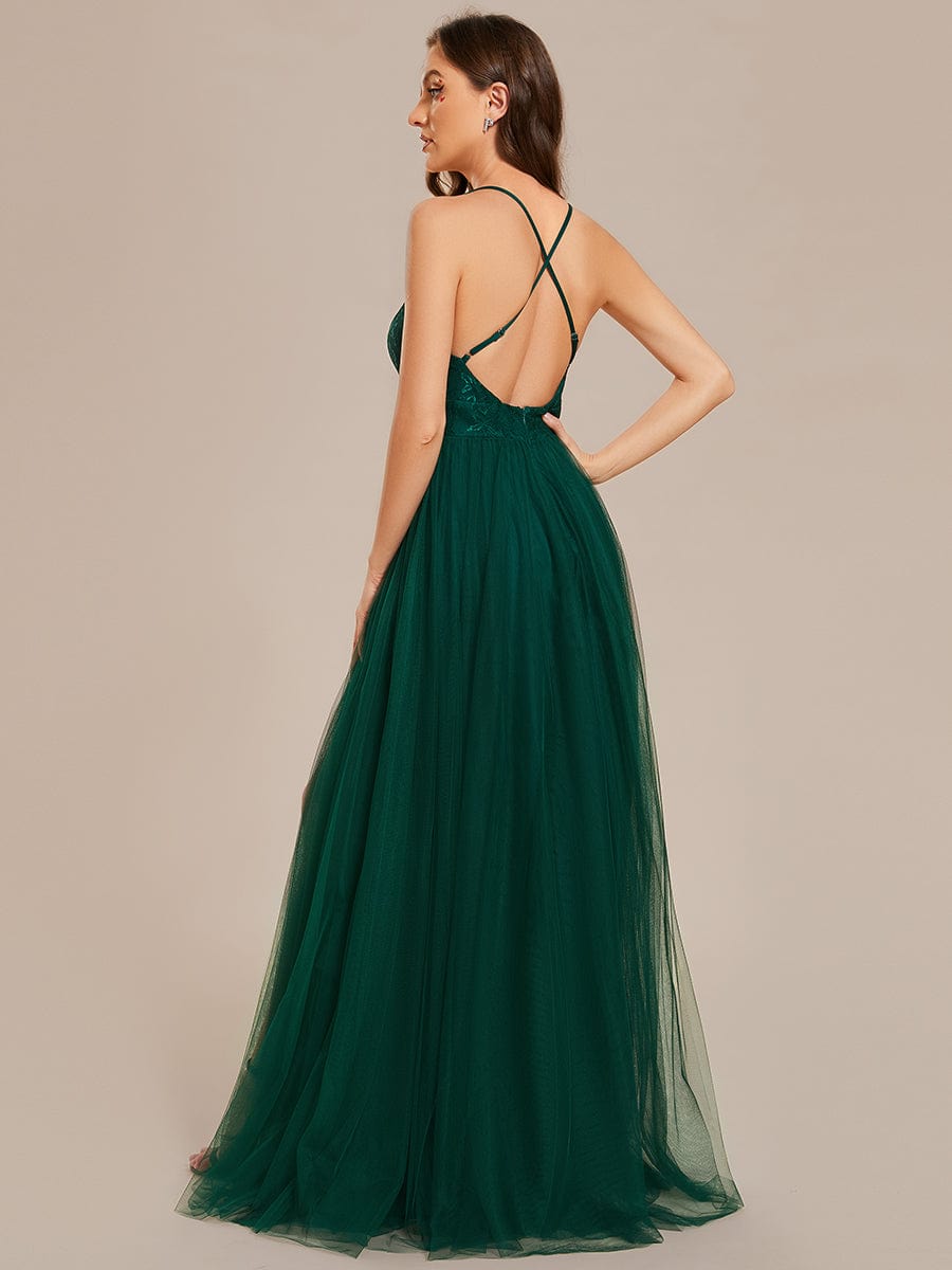 Side view of the dark green A-line tulle bridesmaid dress, showcasing the flowing skirt and high slit.