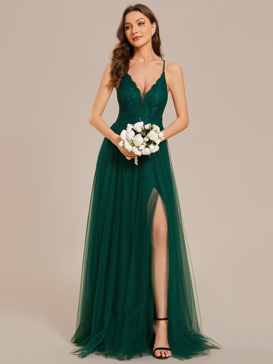 Close-up of the delicate lace top and spaghetti straps on the dark green bridesmaid dress.