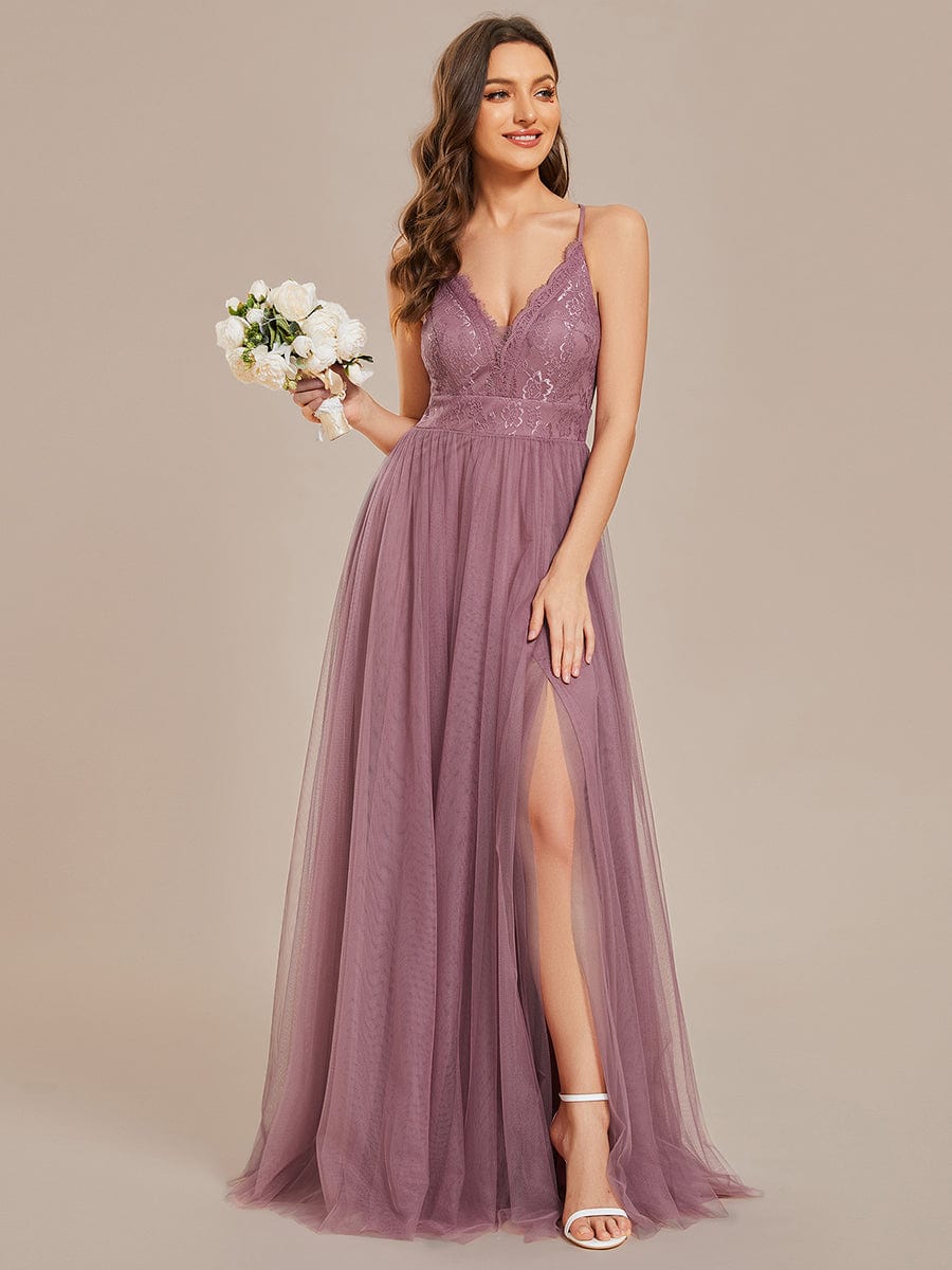 Model posing gracefully in the dark green A-line tulle bridesmaid dress, emphasizing its elegant drape.