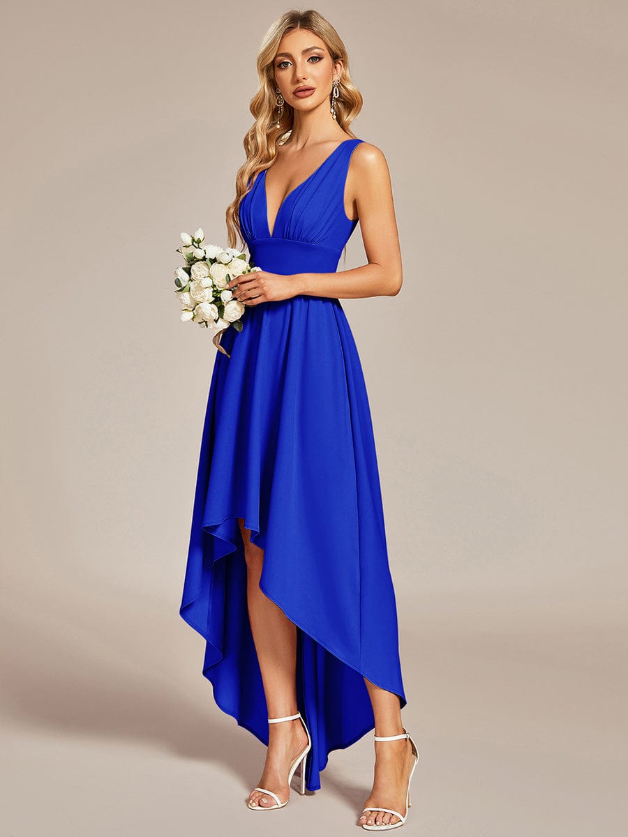 Model in a light blue A-line deep V-neck high-low dress, side profile.