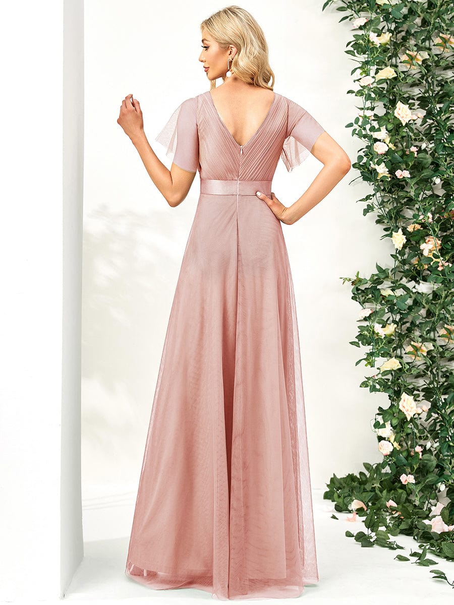 Side view of a pink tulle bridesmaid dress with short sleeves.