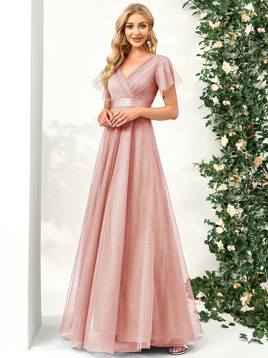 Back view of a pink double V-neck tulle bridesmaid dress.