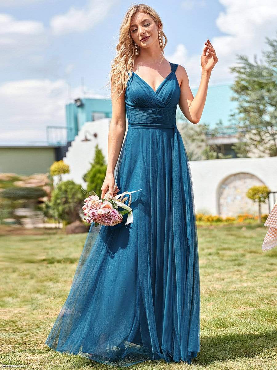 Front view of a model in a mint green tulle bridesmaid dress.