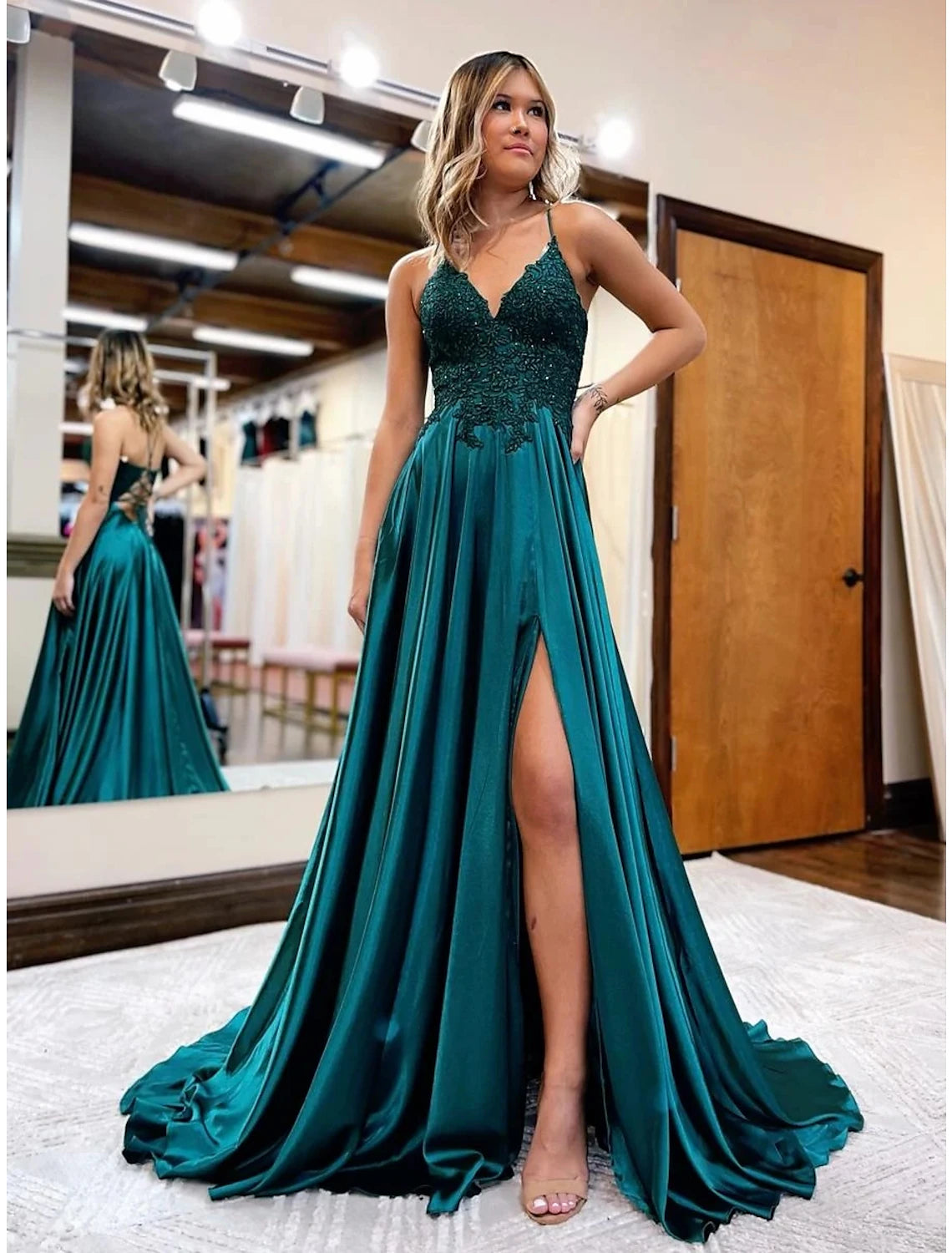 Close-up of the V-neckline and intricate beading appliques on the satin formal dress.