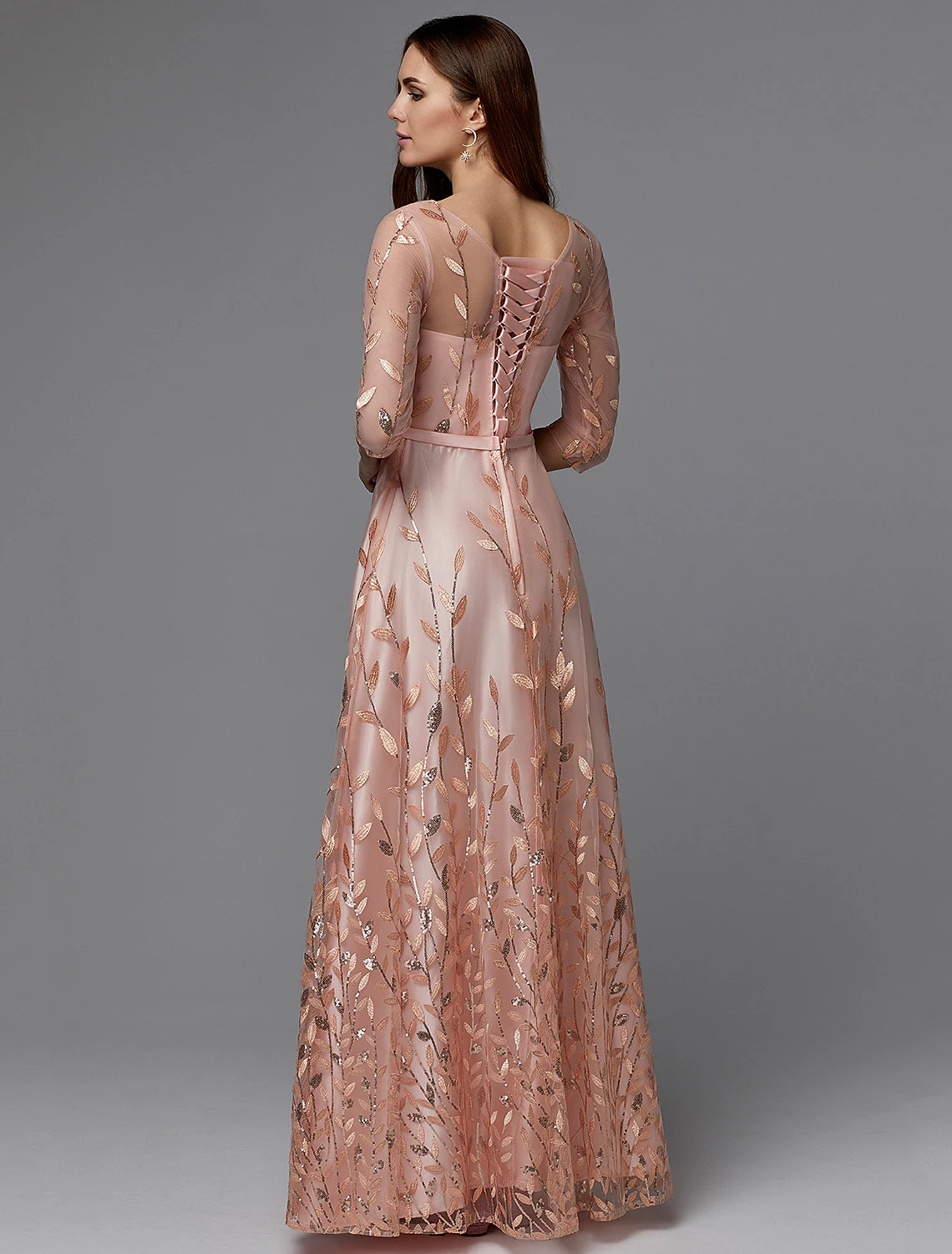 Back view of the A-line floral lace dress, showing illusion back and floor-length skirt.