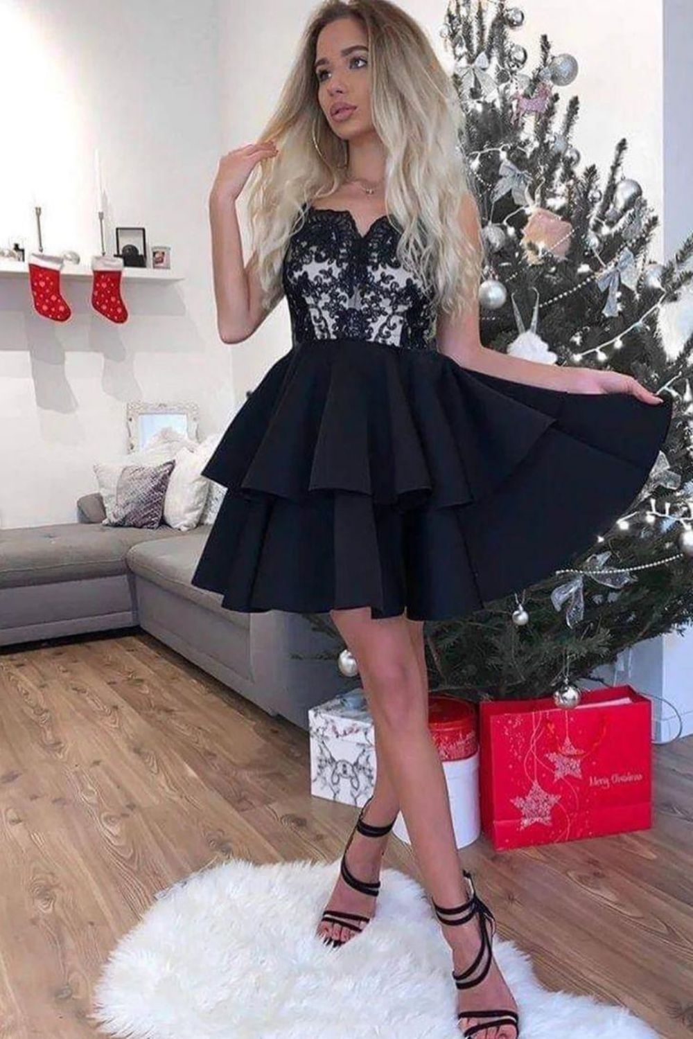 Back view of the black mini homecoming dress, showcasing applique and design.