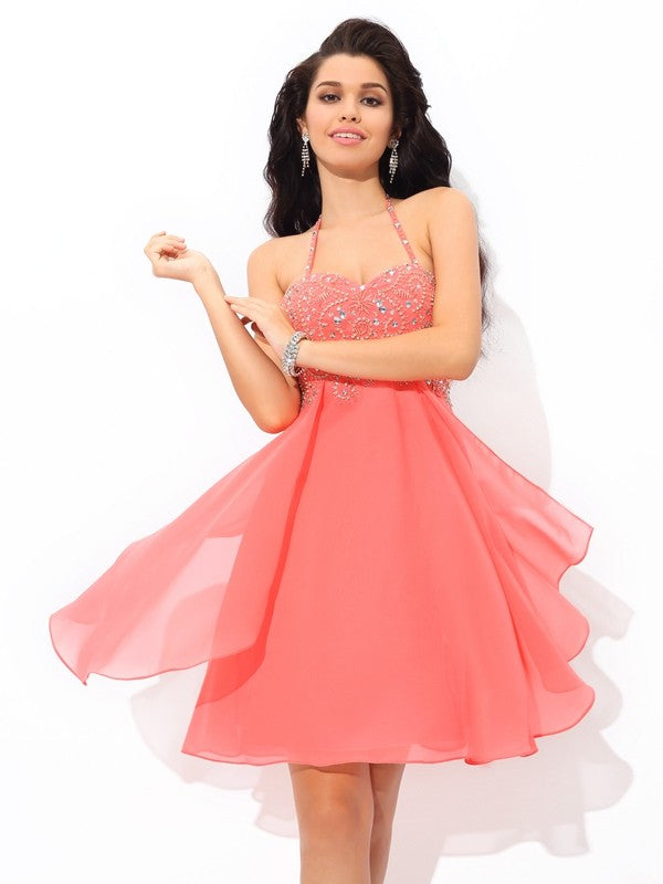 Model wearing an elegant A-line halter beaded short chiffon cocktail dress.