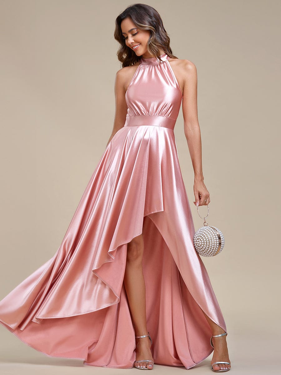 Model wearing a pink A-line halter high-low satin bridesmaid dress.