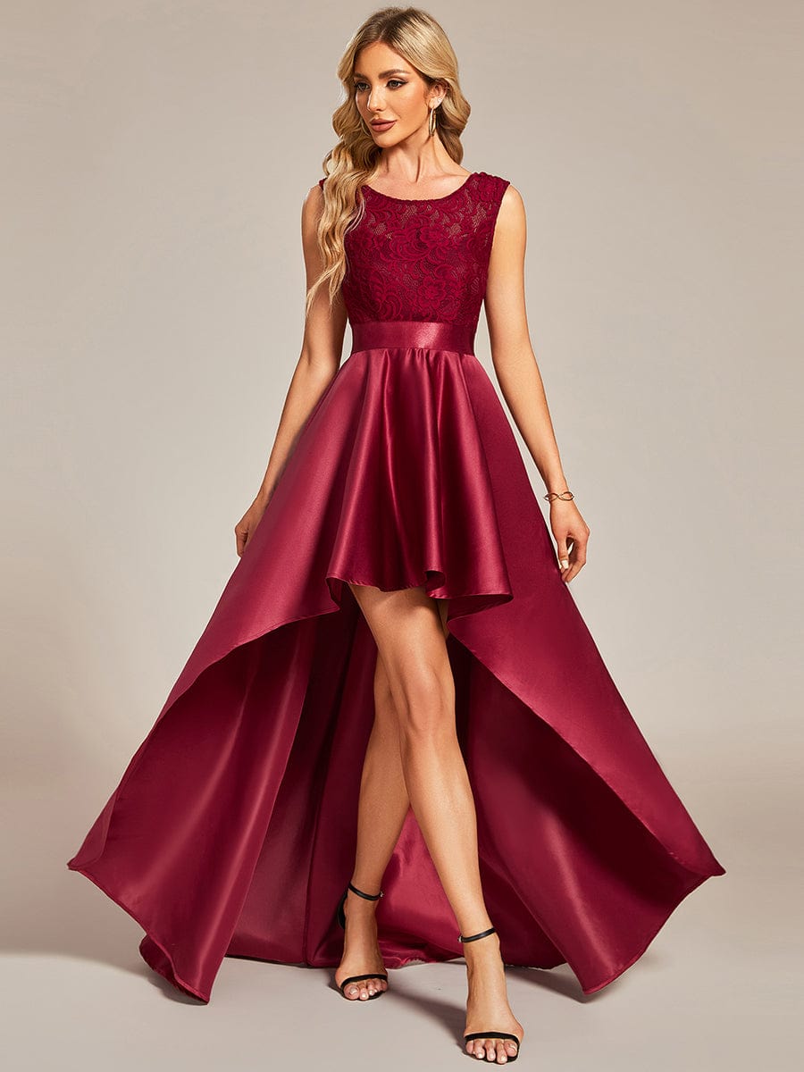 Model wearing a burgundy high-low lace top prom dress.