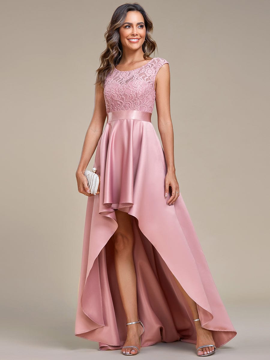 Model wearing an olive green high-low lace top prom dress.