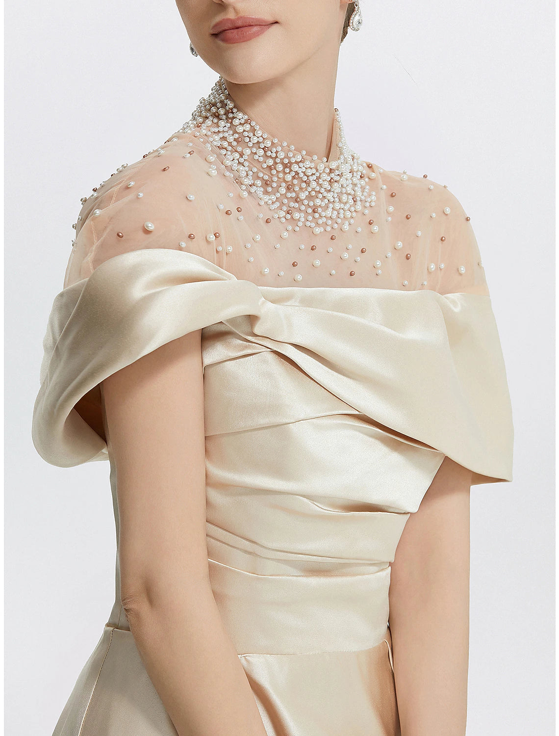 Close-up of the high neck and ruched pearl details on the Italy satin gown.